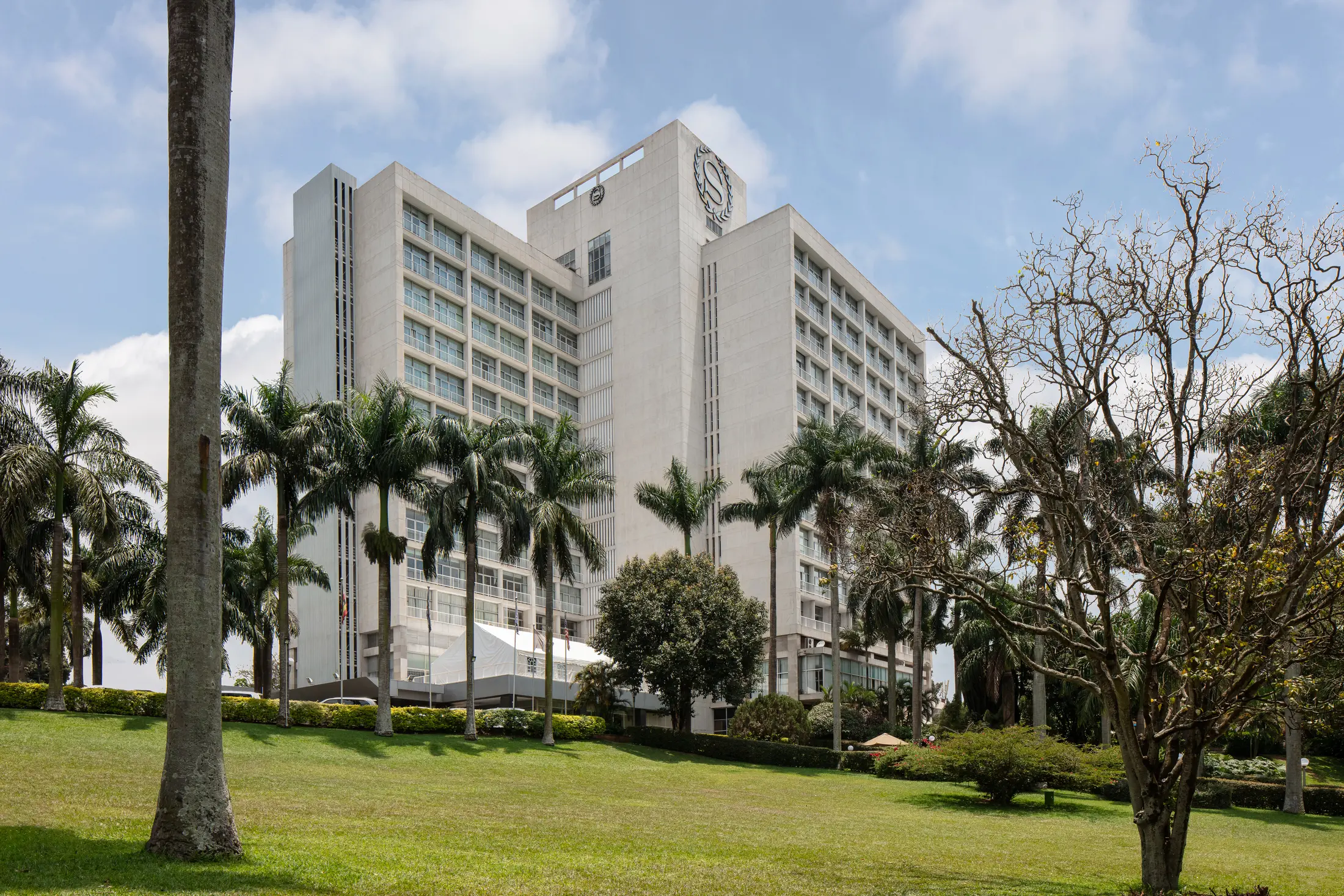 Sheraton Kampala exterior framed by gardens and palms